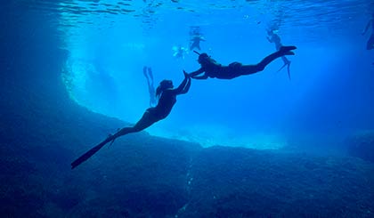 Freedivers in a cave during a freediving cruise in Croatia